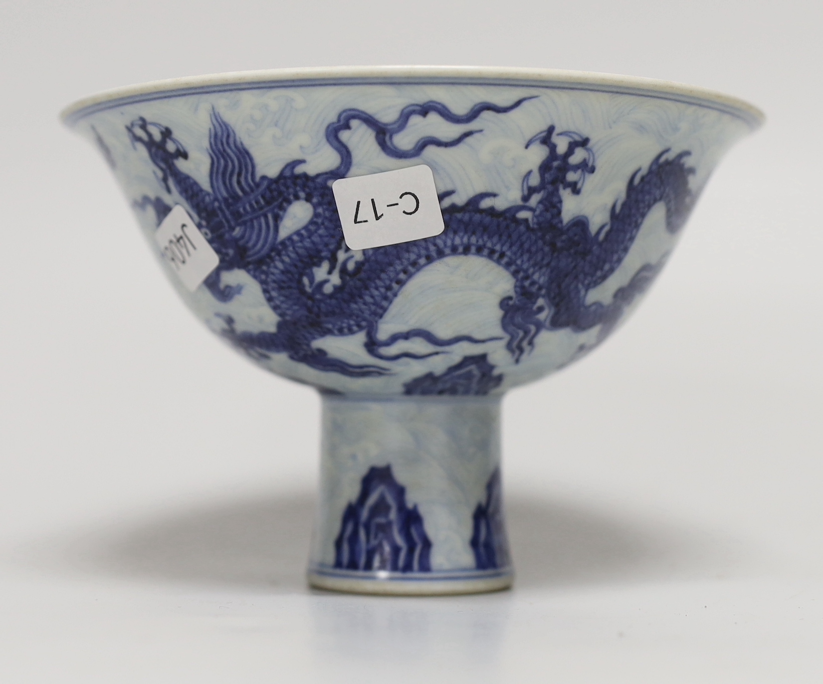 A Chinese blue and white porcelain stem bowl decorated with dragons, housed in a fitted case, 10cm high